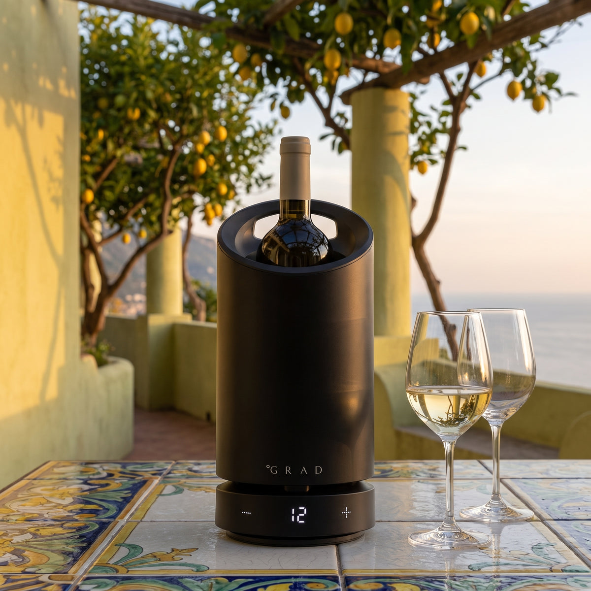 GRAD No.1 Black Edition keeping white wine at 12 °C on a tiled terrace with lemon trees and a sea view